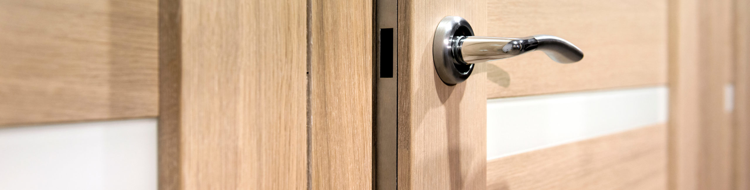 Part of wooden open door with silver door-handle